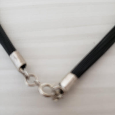 Silver hammered pendant on a multi strand black cord - LB Designs
